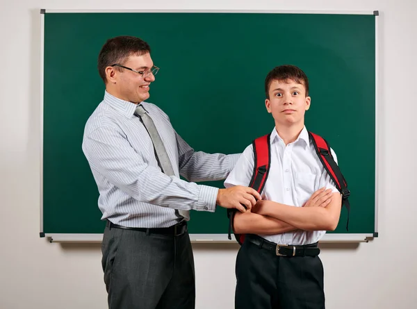 Portrait of a teacher and schoolboy playing at blackboard background - back to school and education concept — Stock Photo, Image