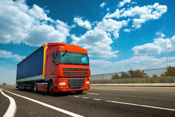 Red truck is on highway - business, commercial, cargo transporta — Stock Photo, Image