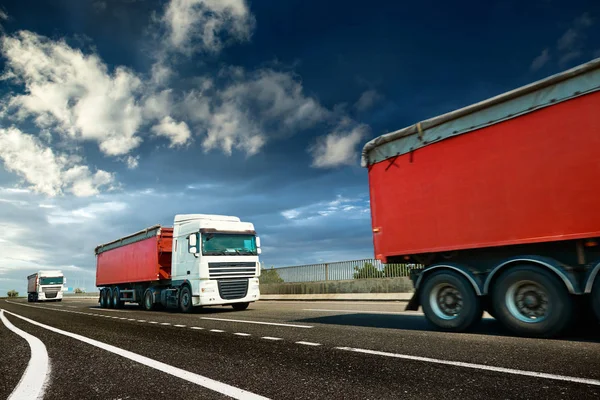 Red trucks is on highway - business, commercial, cargo transportation concept, clear and blank space on the side view — Stock Photo, Image