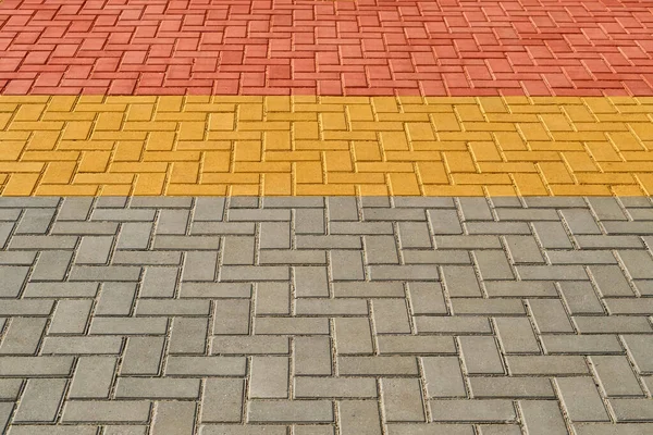 Yellow, red and grey paving tiles for background or texture — Stock Photo, Image