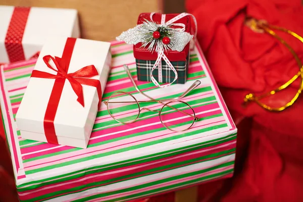 Close-up of gift boxes and red sack - Merry Christmas and Happy Holidays concept — Stock Photo, Image