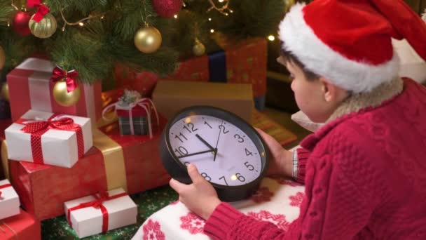 Teen Boy Waiting Santa Watching Clock Lying Indoor Decorated Xmas — Stock Video