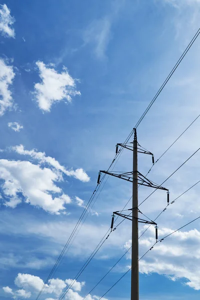 high-voltage electric line against a bright beautiful sky