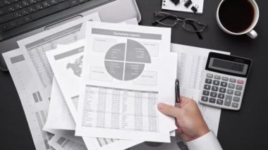 Finansal beyannamelerle çalışan iş adamlarının üst görüşü. Defteri, kalemi ve bir sürü şeyi olan modern siyah ofis masası. Düz masa düzeni.