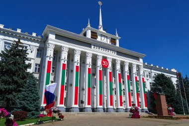city hall of the Tiraspol, Transnistria, Moldova - the city administration building is decorated with state flags and banners to celebrate the 30th anniversary of independence clipart