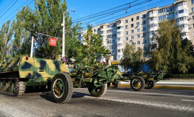 military parade in the city, ordered military equipment, tanks, guns and other weapons in the street for celebration clipart