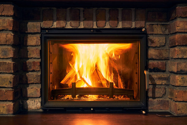 fireplace and fire close view as object or background, brick wall