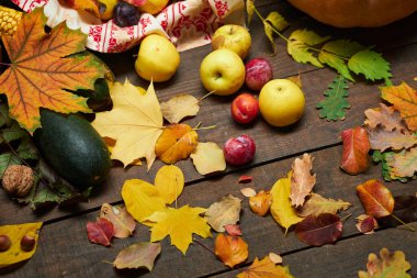 Arka plan olarak kırsal bir yaşam sürmeye devam ediyor. Yapraklar, sebzeler, meyveler, fındıklar ve diğer doğal besin maddeleri ahşap tahtalarda.