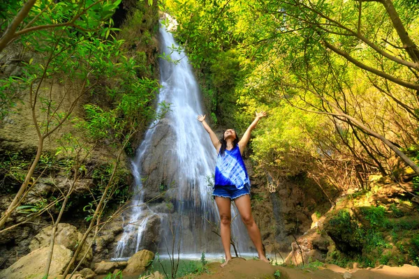 Happy woman at waterfall Royalty Free Stock Photos