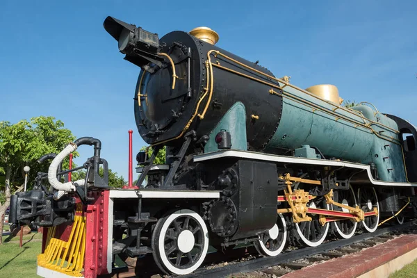 Antique green  locomotive stream train on railway track. old and classic period engine against blue sky.