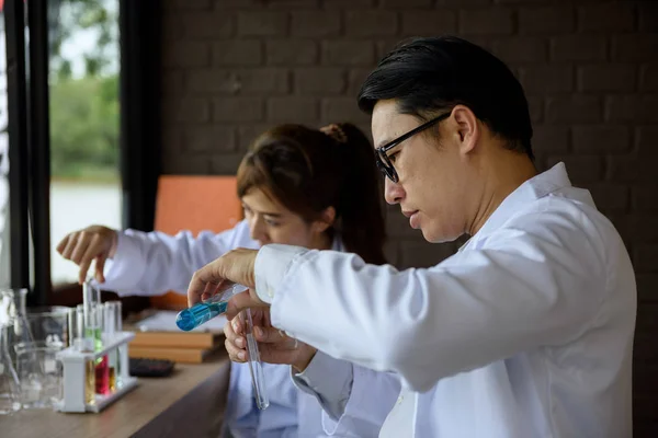 scientist test chemical liquid in lab