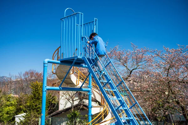 Menino jogar slider no parque de primavera, Matsumoto — Fotografia de Stock