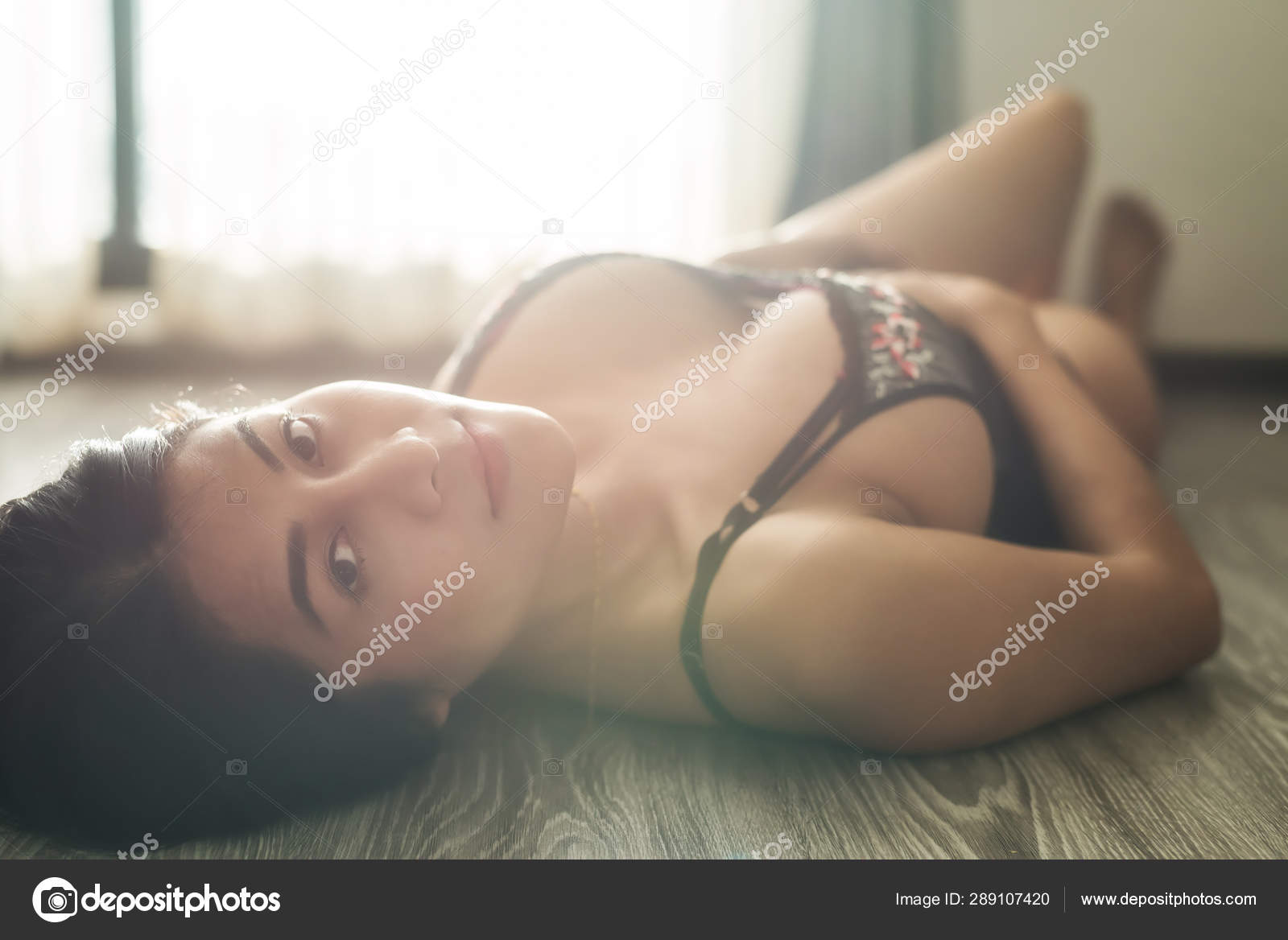 Sexy Asian woman with flare light in room Stock Photo by ©blanscape 289107420