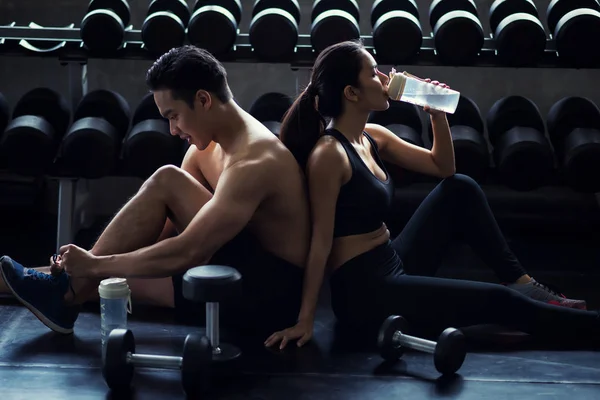 Healthy couple relax after dumbbell exercise