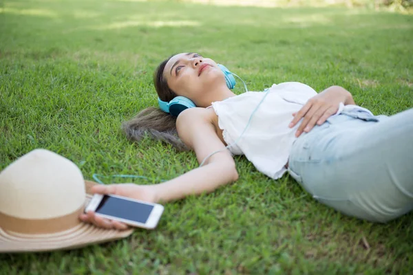 Asian woman listen online music in park