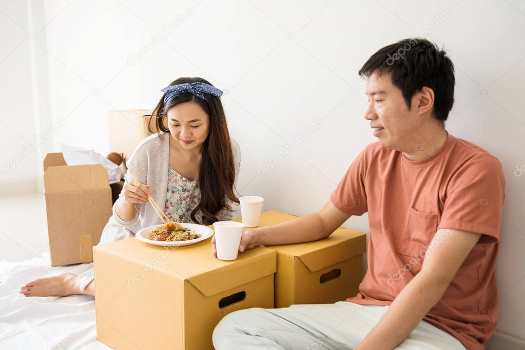 couple eat roasted duck noodle in new house