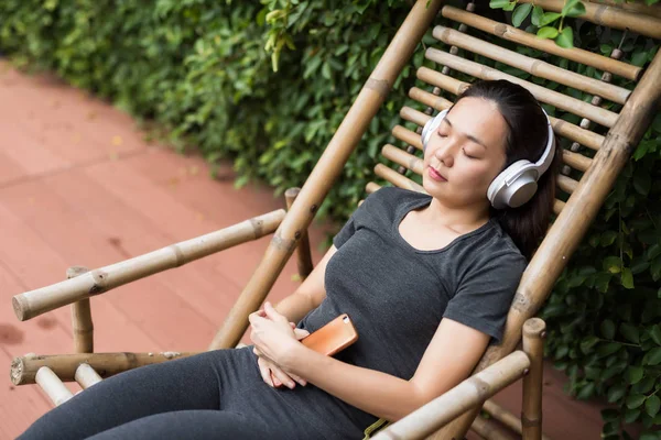 woman listen online music in park after running