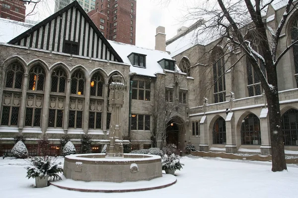 Fourth Presbyterian Church exterior with falling white snow in winter in Chicago, IL, USA. Antique architecture located in Chicago loop downtown.