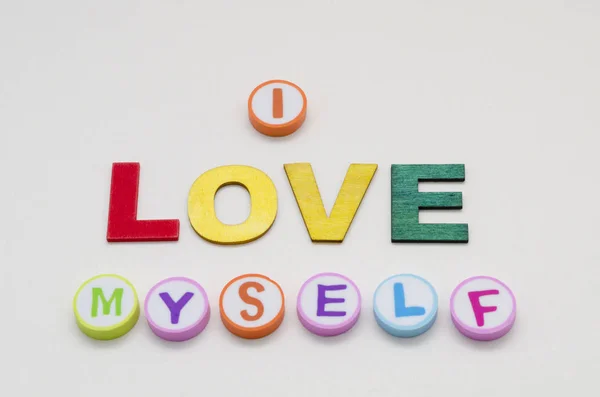 I love myself phrase made from colorful circles and letters against white background