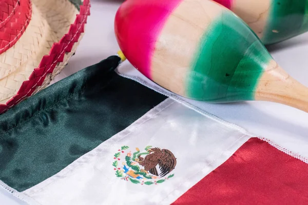 Hat, mexican flag and maracas on white background. Mexican Independence Day decoration