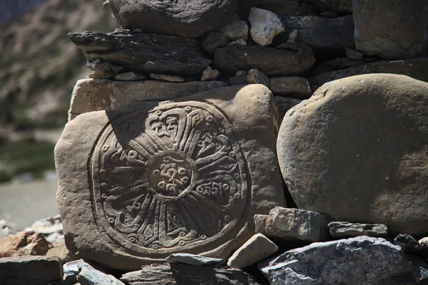 Buddhist flower of life engraved on the rock.