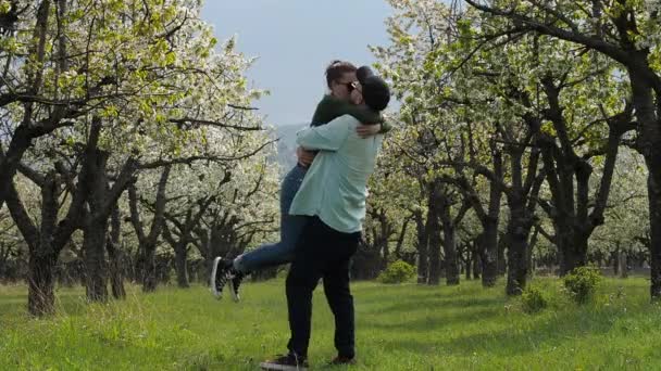 A young couple in love stroll together through a beautiful forest with their pet dog. In slow motion. — Stock Video