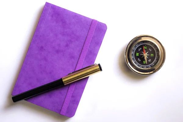 purple book and pen on white background