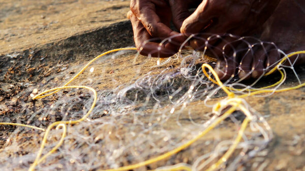 Indian man preparing the fishing net