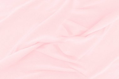 Yumuşak pembe kumaş dokusu arka planı. Duvar kağıdı veya arkaplan için soyut kumaş ipeği