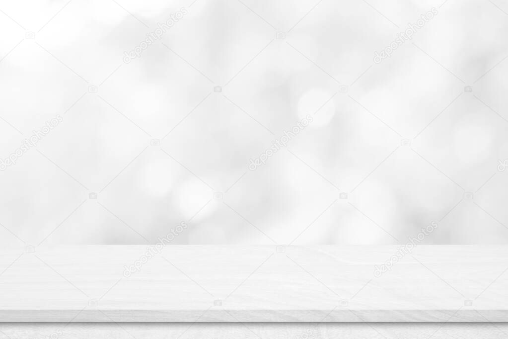 White wood tabletop over blur white bokeh light background. Empty wood shelf for product display, banner or mockup.