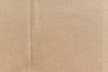 Bej renkli karton desen arka planı. Eski, kahverengi kağıt kutu yüzeyi.