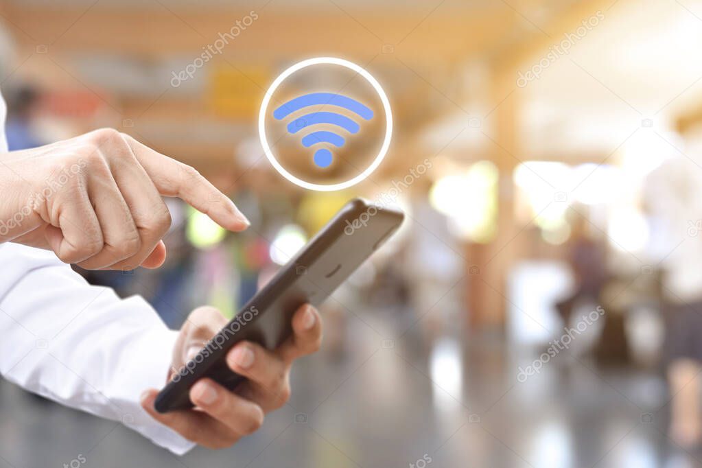 Hand using mobile smartphone with wifi icon. Idea for business communication social network.