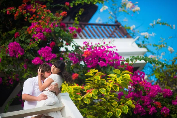 Gli Sposi Abbracciano Appassionatamente Sul Balcone Uno Sfondo Fiori — Foto Stock