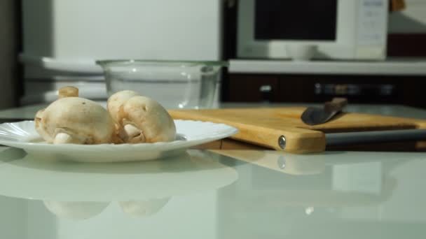 Mani di chef maschio che tagliano funghi freschi su un asse di legno — Video Stock