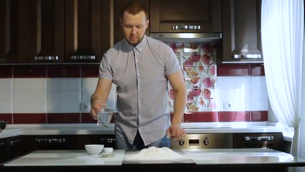 Chef macho drena agua en harina para hornear — Vídeo de stock