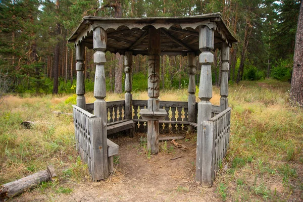 A place for tourists in the forest, a large old wooden gazebo
