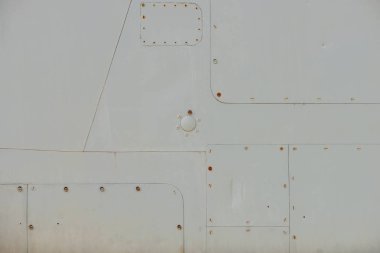 Old detail of a military aircraft, metal texture with rivets clipart