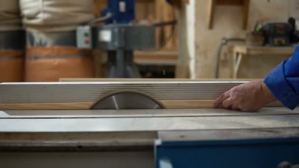 Carpenter at work at his workshop, wood processing on a woodworking machine — Stock Video