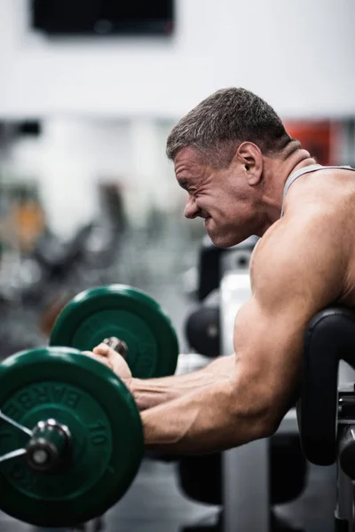 Velký Atletický Muž Vlaky Tělocvičně Školení Biceps Činka Lavičce — Stock fotografie