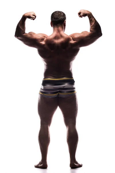 Grande Homem Poderoso Mostra Seus Bíceps Volta Estúdio Sem Camisa — Fotografia de Stock