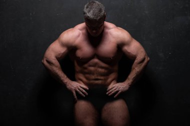 Studio grunge siyah duvar gömleği kasların gösterilen büyük güçlü bir adam