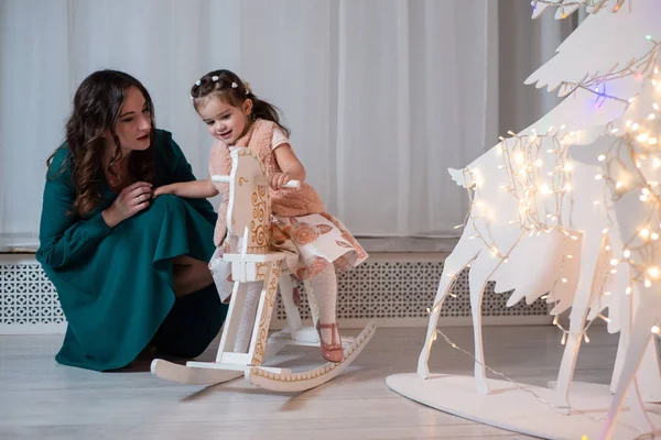 Una Niña Con Vestido Rosa Sentada Caballo Madera Junto Madre — Foto de Stock