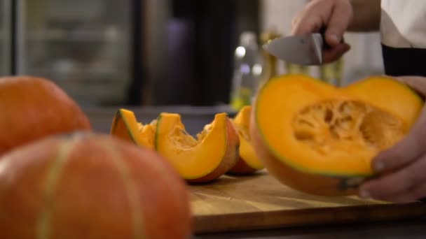 Chef coupe une grande citrouille dans la cuisine pour préparer un délicieux plat — Video