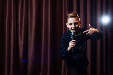 küçük çocuk mikrofon şarkı. karaoke çocuk. moda saç kesimi