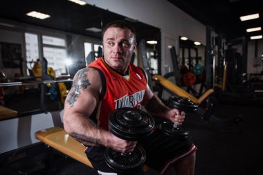 Rusya, Samara - 18 Aralık 2018: Büyük atletik adam trenler jimnastik salonu. Egzersiz sonrası dinlenme