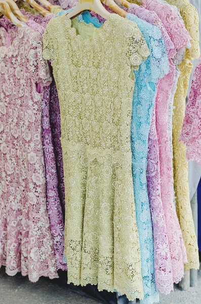 Row of lace dress hanging in market — Stock Photo, Image