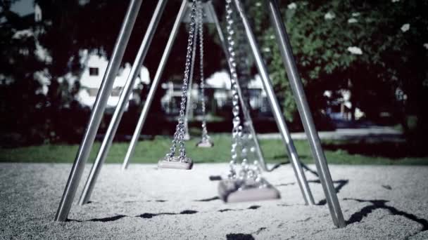 Columpios vacíos en el parque infantil — Vídeos de Stock