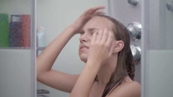 Teen girl bathing under shower Stock Video Footage by ©VaLiza