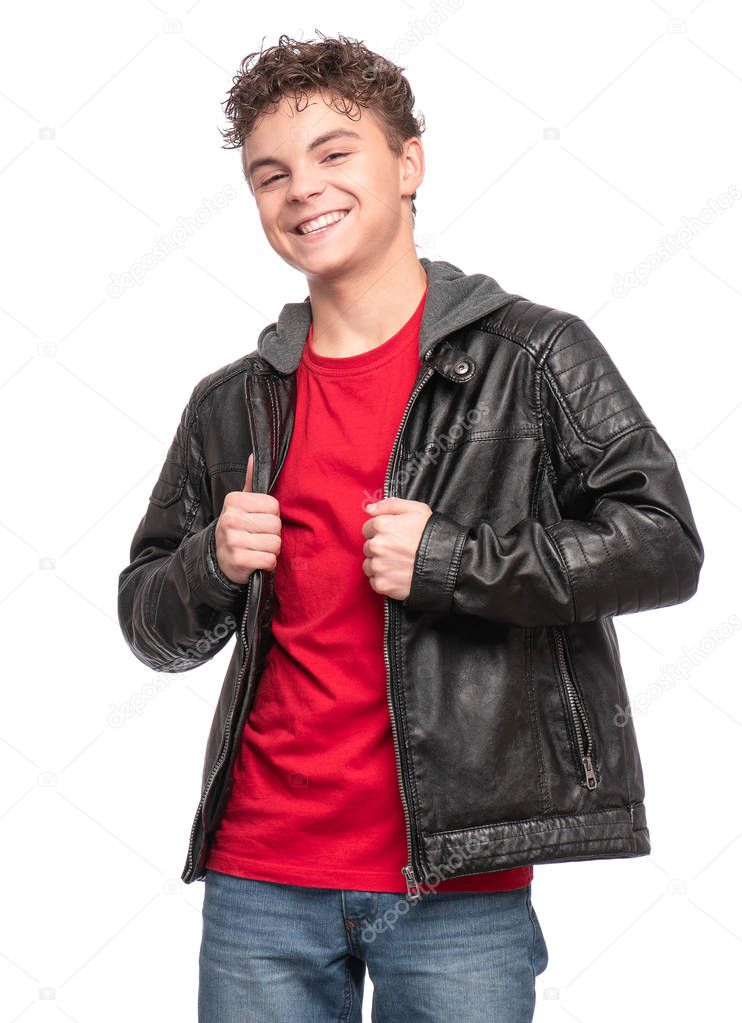 Portrait of a Handsome brutal Teen Boy in a black Leather Jacket and red T-shirt. Smiling fashion Child Model isolated on White background. Funny Teenager is looking very Happy.