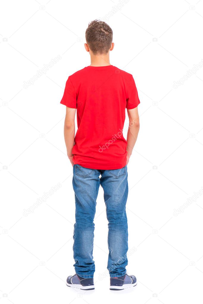 Full length portrait of young caucasian teen boy - rear view, isolated on white background. Funny teenager - back view. Handsome child with hands in pockets.